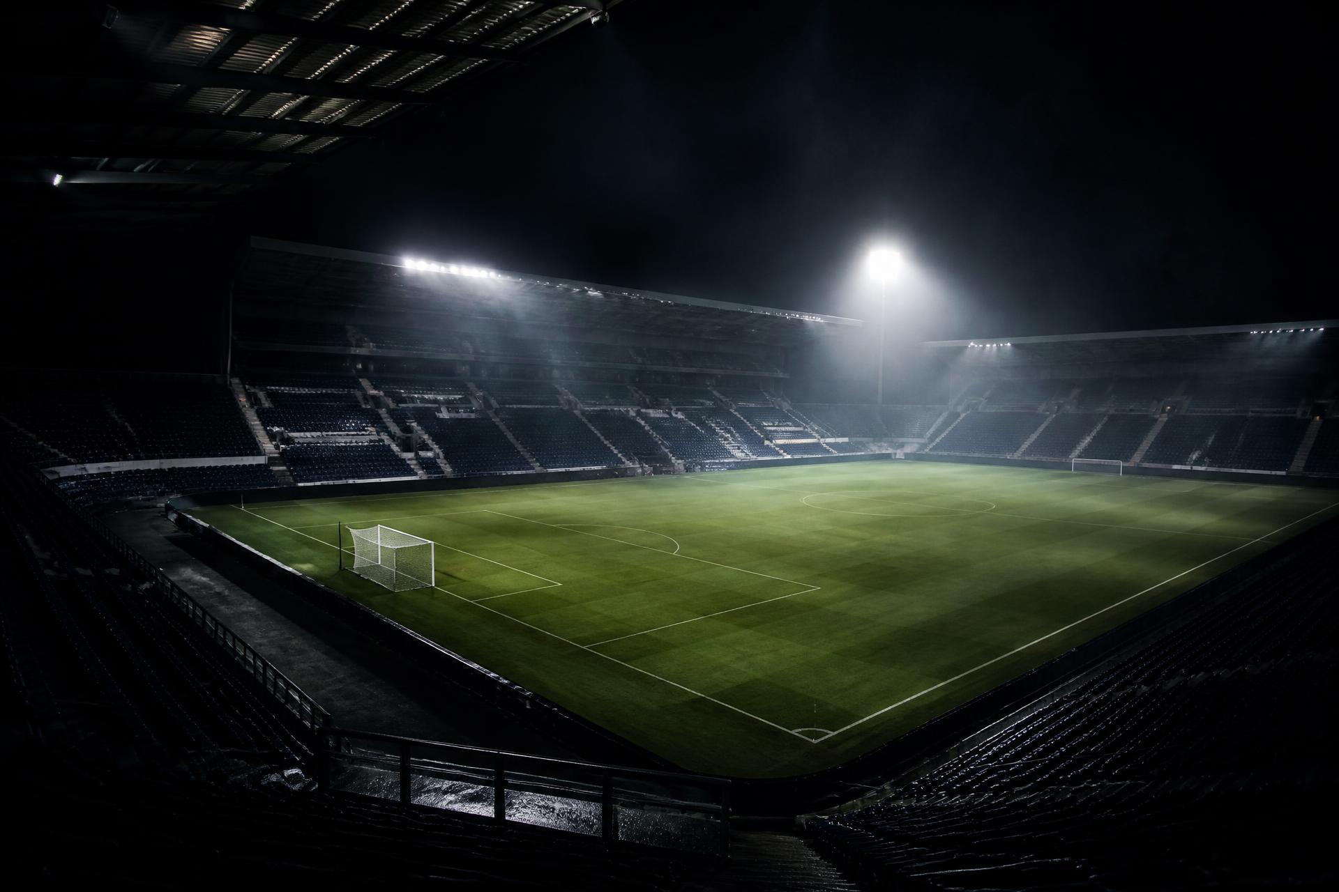 Floodlit Scottish football stadium at night